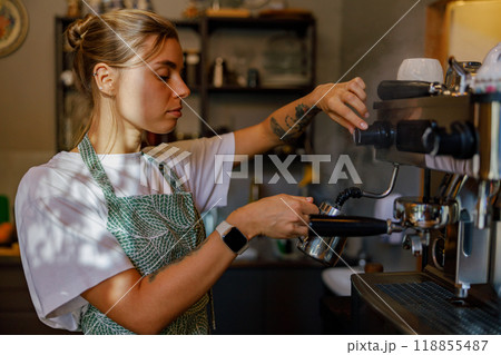 Barista Preparing Coffee in a Cozy Caf Setting Barista Preparing Coffee in a Cozy Caf Setting 118855487