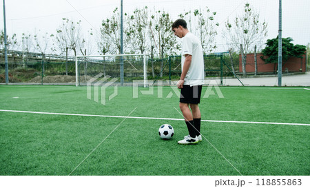 Teenager Does Freestyle Soccer Dribbles In The Field Teenager Does Freestyle Soccer Dribbles In The Field 118855863
