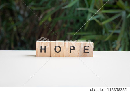 Hope, word on top of white table. Hope, word on top of white table. 118858285