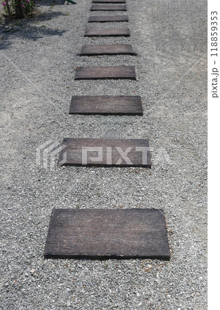 Walkway with wooden pattern stone slabs is placed in the backyard. 118859353