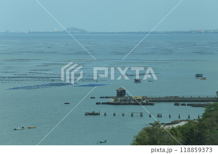 Oyster and mussel farm on the coast of Chonburi Province and there is a bridge leading into the sea. Oyster and mussel farm on the coast of Chonburi Province and there is a bridge leading into the sea. 118859373
