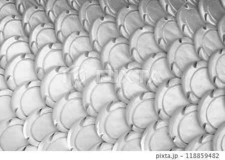 White patterns of stucco shaped like fish scales. White patterns of stucco shaped like fish scales. 118859482