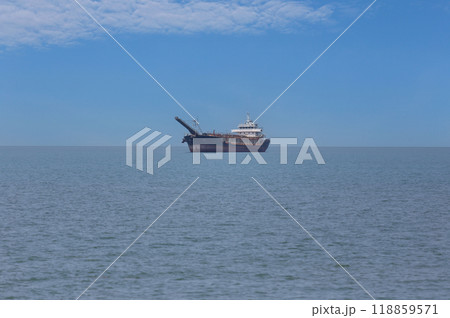 Sand suction boat moored on the sea shore of Jomtien Beach of Pattaya City. Sand suction boat moored on the sea shore of Jomtien Beach of Pattaya City. 118859571