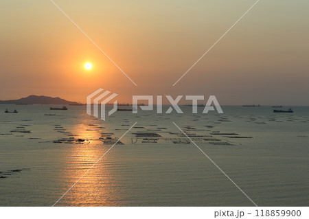 Sea is filled with cargo ships and fishing boats at dusk. Sea is filled with cargo ships and fishing boats at dusk. 118859900