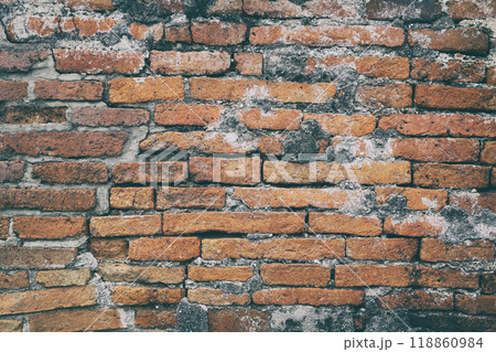 Surface of the red brick wall is old, dirty and covered with black mold. 118860984