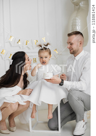 Family celebrates child's birthday with joy and love 118861414