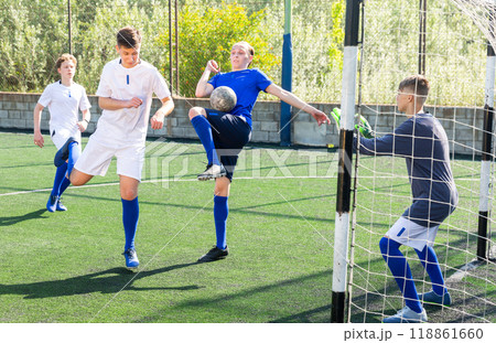 Youthful football players challenging for ball Youthful football players challenging for ball 118861660