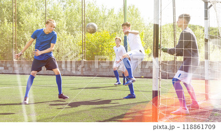 Youthful football players challenging for ball 118861709