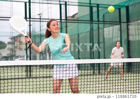 Young emotional women playing paddle tennis outdoors 118861710