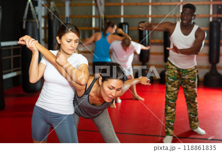 Women exercising during group self-defense training Women exercising during group self-defense training 118861835