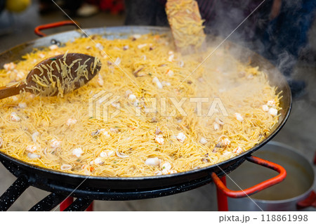 Cooking the Valencian dish Fideua de Marisco Cooking the Valencian dish Fideua de Marisco 118861998