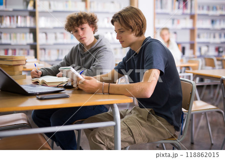 Teenage boys in library 118862015