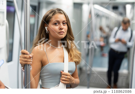 Young girl standing in wagon with wireless headphones on airs 118862086