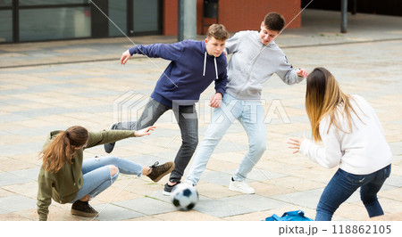 Cheerful schoolchildren are playing football 118862105