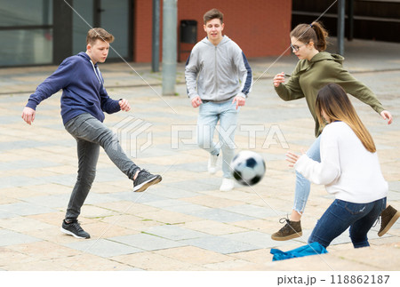 Cheerful schoolchildren are playing football 118862187