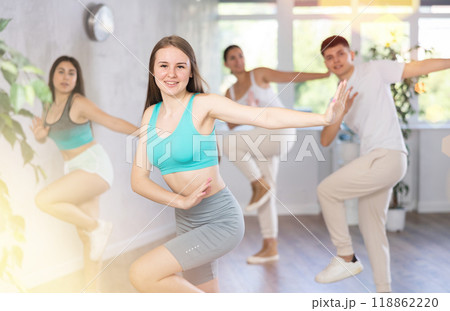 Girl teen perform choreographic exercise and teach energetic waacking dance with friends 118862220
