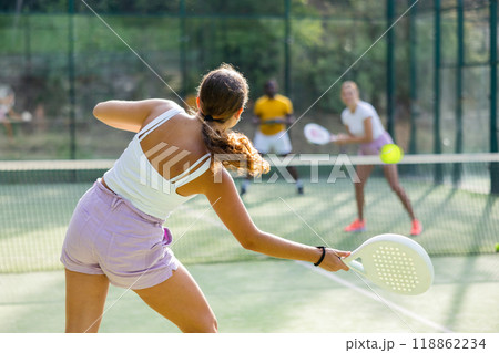 European woman tennis player in padel tennis playing on the outdoor court European woman tennis player in padel tennis playing on the outdoor court 118862234