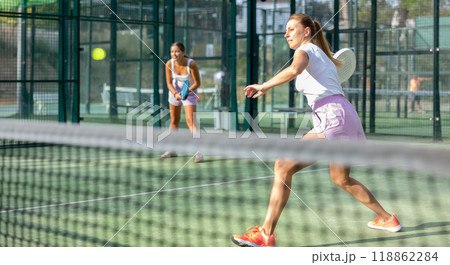 Two women tennis players playing padel 118862284