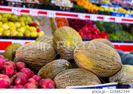 Sweet melons on the counter of the fruit store Sweet melons on the counter of the fruit store 118862394