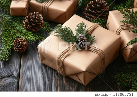 Pine cones with fir branches and Christmas gift boxes on wooden background 118863751
