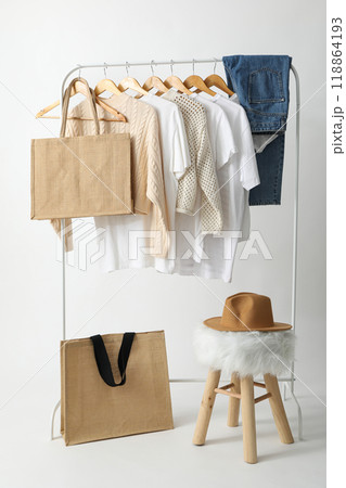 A bag hangs on a hanger with clothes A bag hangs on a hanger with clothes 118864193