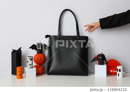 Black bag with Halloween decorations on a white background Black bag with Halloween decorations on a white background 118864210