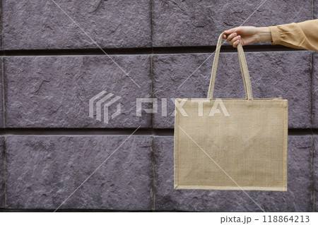 A bag in a woman's hand on a brick background A bag in a woman's hand on a brick background 118864213