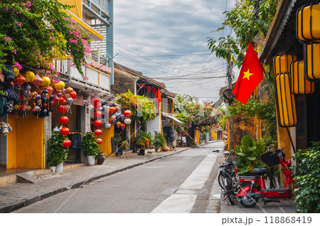 Streets with traditional ancient yellow houses in old town in Hoi An city in Vietnam Streets with traditional ancient yellow houses in old town in Hoi An city in Vietnam 118868419
