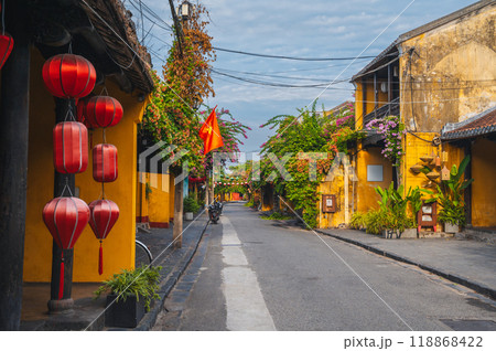 Streets with traditional ancient yellow houses in old town in Hoi An city in Vietnam at summer day Streets with traditional ancient yellow houses in old town in Hoi An city in Vietnam at summer day 118868422
