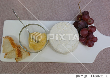 fresh ricotta cheese with linden white light honey Fresh homemade dairy ricotta cheese, close-up opening white net bag fresh ricotta cheese with linden white light honey Fresh homemade dairy ricotta cheese, close-up opening white net bag 118869524