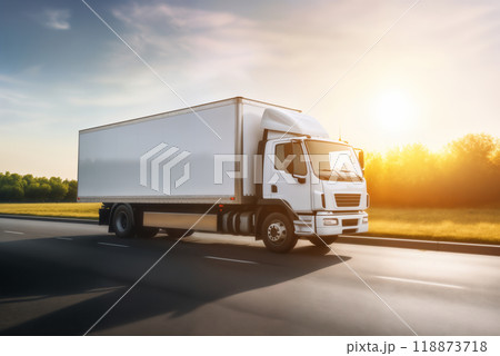 A white truck is driving on the road against the background of a summer landscape 118873718