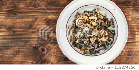 Dried mushrooms on rustic wooden table. 118874256
