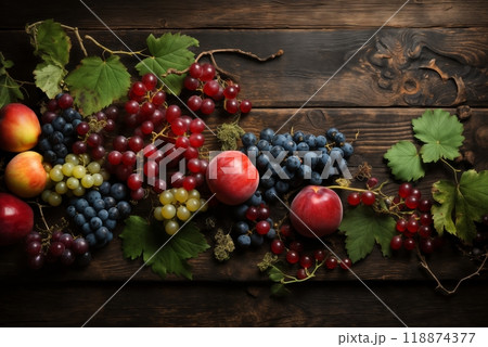 still life with bunches of grapes, berries and fresh and juicy fruits against a dark old wooden background, rural vintage style, the concept of fresh and healthy food 118874377