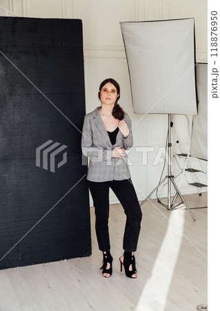 Beautiful fashionable brunette woman posing in photo studio 118876950
