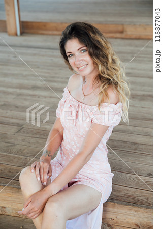 Beautiful woman in summer dress smiling Beautiful woman in summer dress smiling 118877043