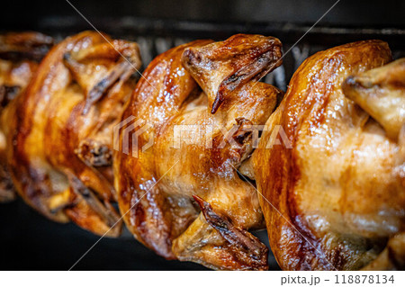 Barbecue roast Chicken in a row turning at industrial roaster grill 118878134