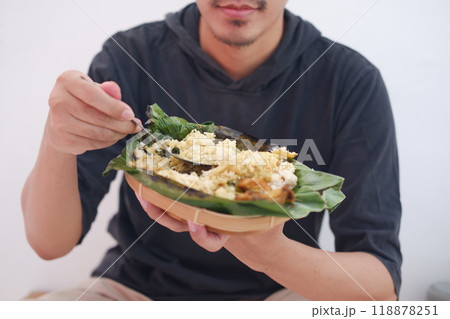 man eating grilled rice from a plate man eating grilled rice from a plate 118878251