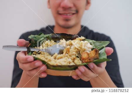 man eating grilled rice from a plate man eating grilled rice from a plate 118878252