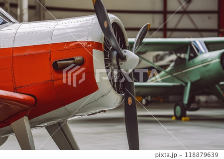 Vintage aircraft with distinctive red and white paint displayed in a hangar showcasing classic aviation at an airfield 118879639