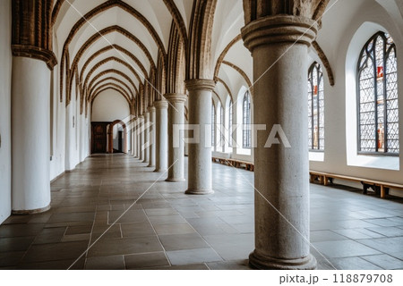 Exploring the serene corridor of a historic building with beautiful arches and architectural details in daylight Exploring the serene corridor of a historic building with beautiful arches and architectural details in daylight 118879708