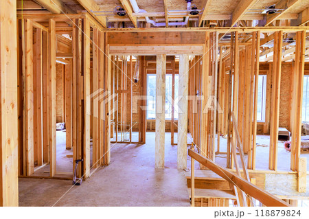 Beam is supported by wooden stud timber framing in interior of newly constructed house. Beam is supported by wooden stud timber framing in interior of newly constructed house. 118879824