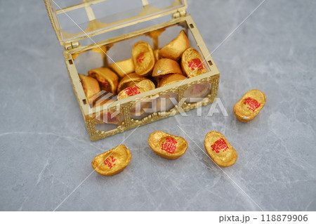 Box filled with gold coins on gray surface, symbolizing wealth and prosperity 118879906