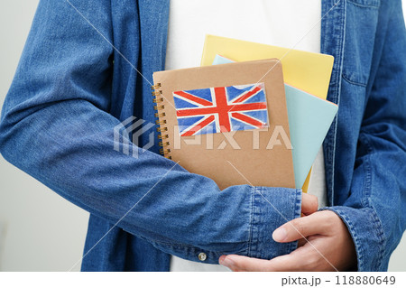 Learning English, Asian teenage student holding book with flag for language program education. 118880649