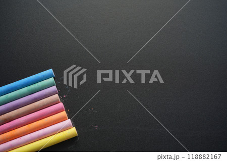 Colorful chalks on blackboard background Colorful chalks on blackboard background 118882167