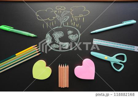 earth doodle with stationery on black chalkboard earth doodle with stationery on black chalkboard 118882168