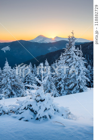 Fantastic orange sunrise in snowy mountains 118882729