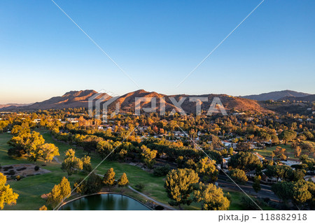 Aerial view of a stunning lake, surrounded by trees and mountains Aerial view of a stunning lake, surrounded by trees and mountains 118882918