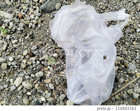 White plastic bag lying on sandstone, Used white plastic bags, plastic trash White plastic bag lying on sandstone, Used white plastic bags, plastic trash 118883161