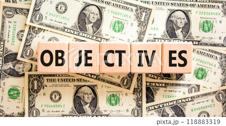 Objectives symbol. Concept word Objectives on beautiful wooden blocks. Dollar bills. Beautiful background from dollar bills. Business objectives concept. Copy space. Objectives symbol. Concept word Objectives on beautiful wooden blocks. Dollar bills. Beautiful background from dollar bills. Business objectives concept. Copy space. 118883319