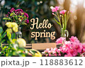 Charming floral display welcomes spring with colorful blooms and wooden sign. Generative AI 118883612